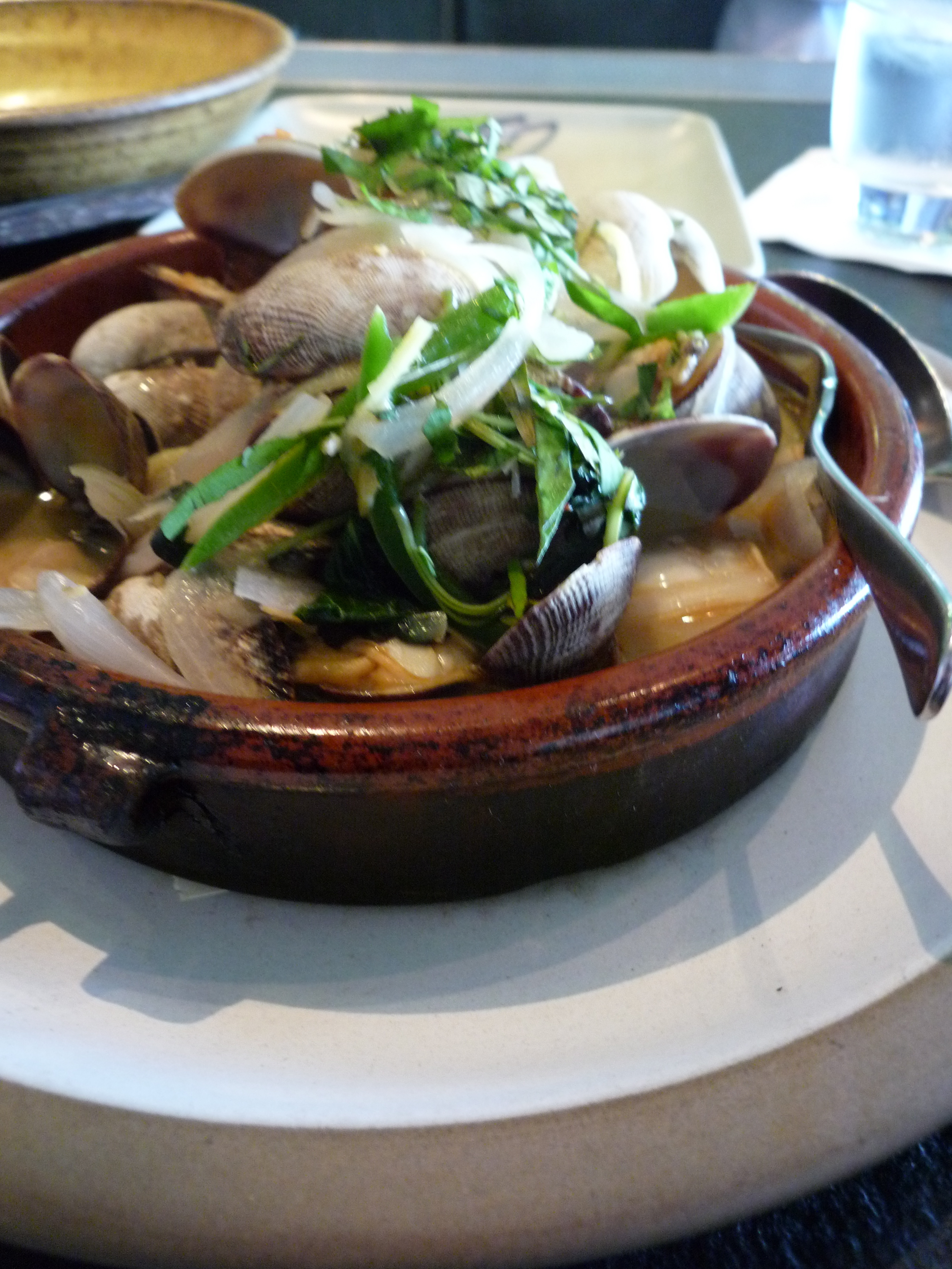 Wood oven roasted manila clams with thai basil, crispy pork belly and fresh chilies