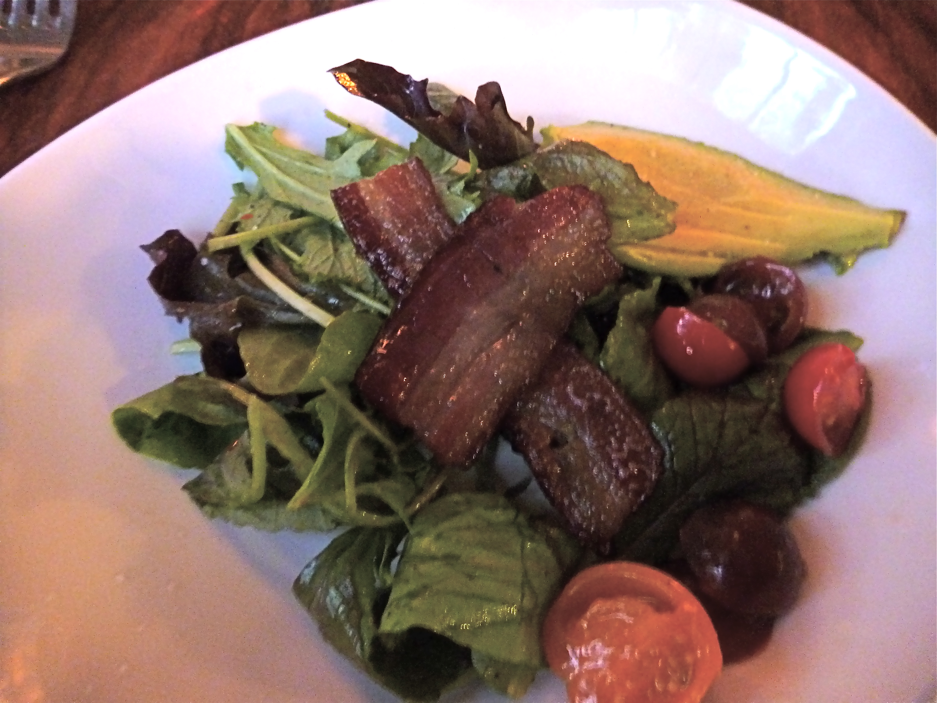 Mixed greens with tomatoes, avocado and bacon